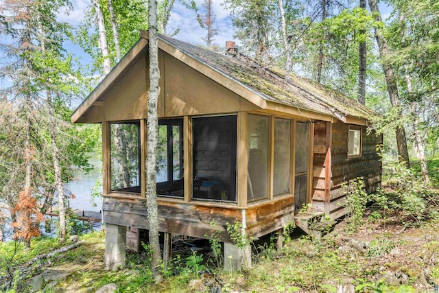 view of outbuilding with a sunroom