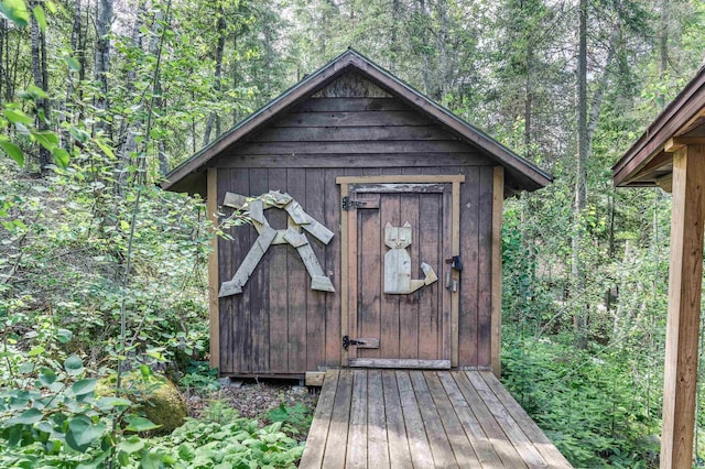 view of shed featuring a forest view