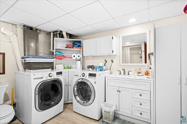 laundry area featuring washer and dryer, recessed lighting, laundry area, and a sink