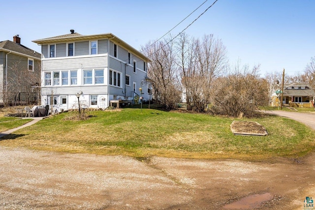back of property with a yard