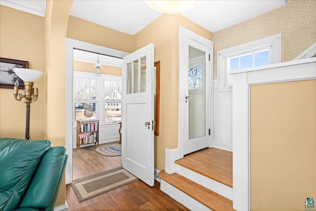 doorway featuring arched walkways and wood finished floors