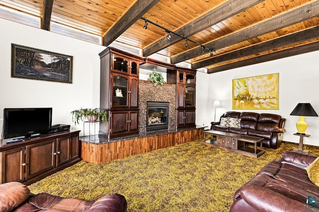 carpeted living room with a tiled fireplace, wooden ceiling, beamed ceiling, and rail lighting