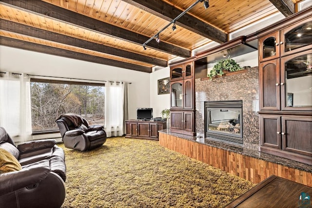 living room featuring wood ceiling, beam ceiling, baseboard heating, and a fireplace