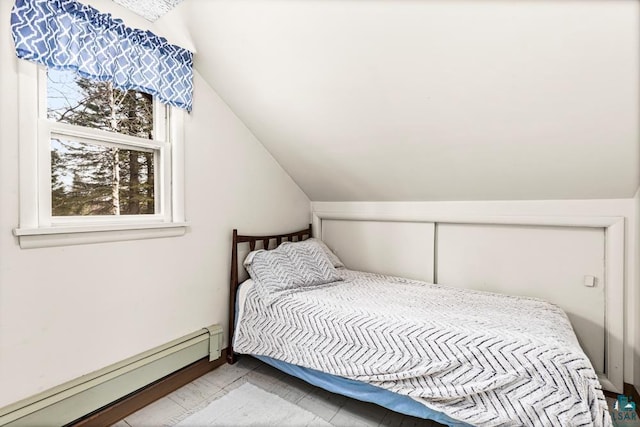 bedroom featuring baseboard heating and vaulted ceiling
