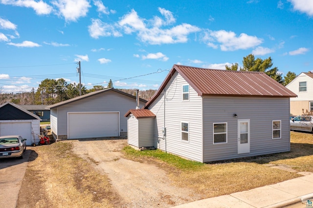 25 4th Ave, Soudan, MN 55782 - exterior space featuring an outdoor structure, metal roof, and a detached garage