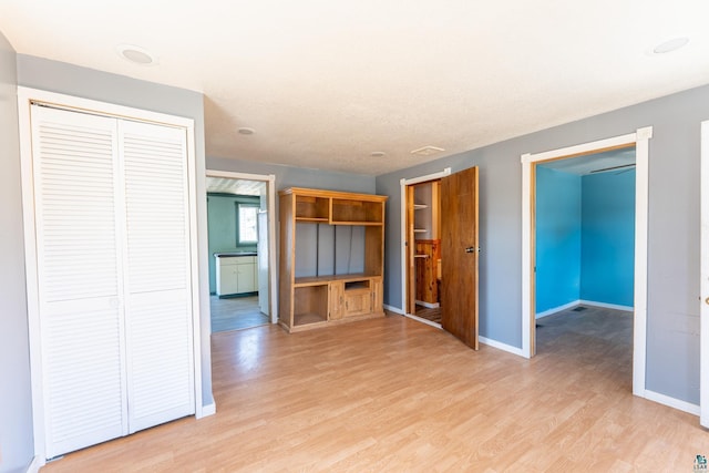 25 4th Ave, Soudan, MN 55782 - unfurnished living room featuring baseboards and light wood-style floors