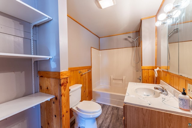 25 4th Ave, Soudan, MN 55782 - full bath featuring washtub / shower combination, vanity, toilet, a wainscoted wall, and wood finished floors