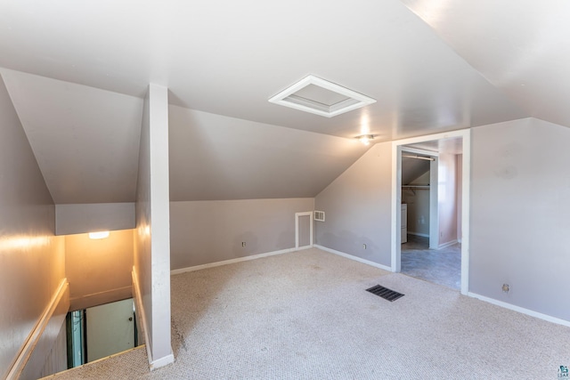 25 4th Ave, Soudan, MN 55782 - additional living space featuring attic access, visible vents, vaulted ceiling, carpet floors, and baseboards