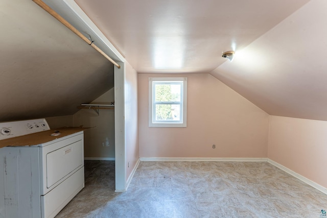 25 4th Ave, Soudan, MN 55782 - additional living space with baseboards, washer / clothes dryer, and vaulted ceiling