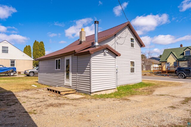25 4th Ave, Soudan, MN 55782 - back of property featuring metal roof and a chimney