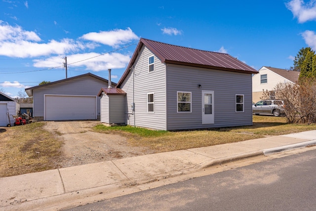 25 4th Ave, Soudan, MN 55782 - view of front of house with metal roof, an outdoor structure, and a garage