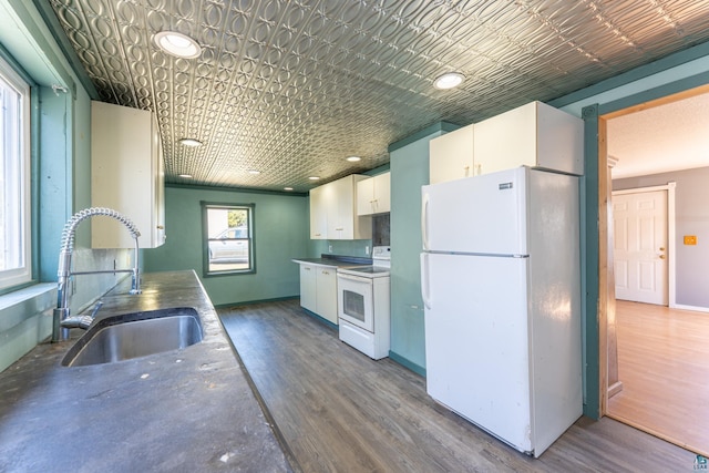25 4th Ave, Soudan, MN 55782 - kitchen featuring a sink, white cabinetry, wood finished floors, and white appliances