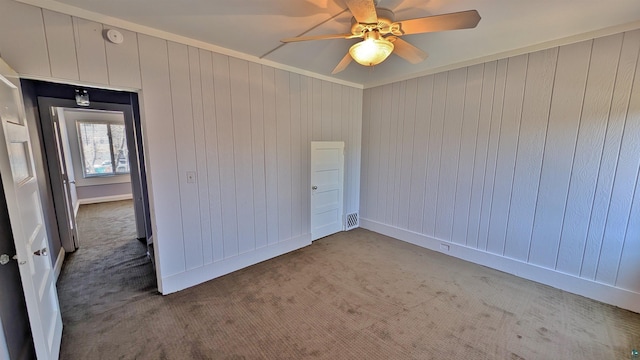 1441 90th Ave W, Duluth, MN 55808 - carpeted spare room with crown molding, wooden walls, ceiling fan, baseboards, and visible vents