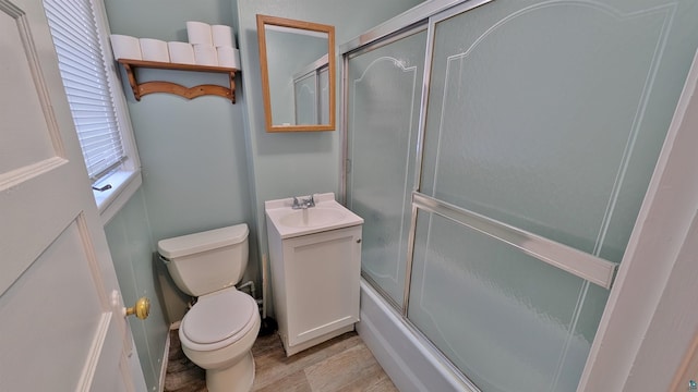 1441 90th Ave W, Duluth, MN 55808 - bathroom featuring toilet, a sink, shower / bath combination with glass door, and wood finished floors