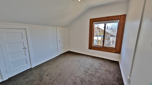 1441 90th Ave W, Duluth, MN 55808 - additional living space with baseboards, lofted ceiling, and dark colored carpet
