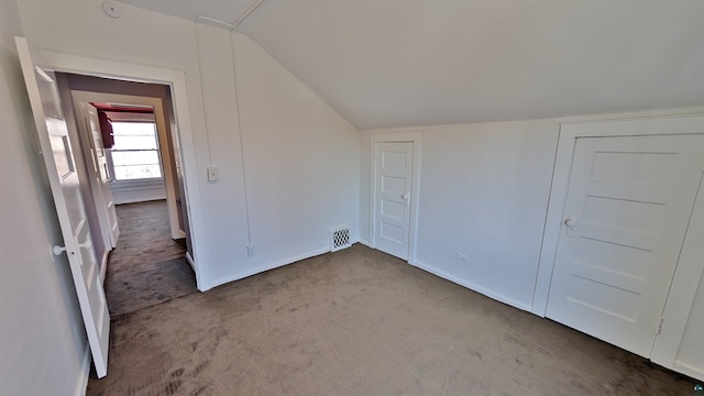 1441 90th Ave W, Duluth, MN 55808 - unfurnished bedroom featuring visible vents, baseboards, a closet, lofted ceiling, and carpet