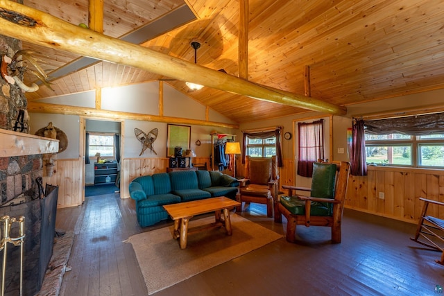 living area with lofted ceiling with beams, wainscoting, hardwood / wood-style floors, a healthy amount of sunlight, and wood ceiling