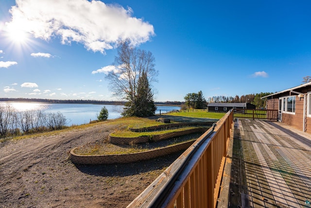 view of community featuring fence and a water view