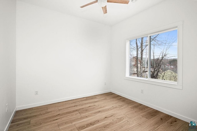empty room featuring baseboards, ceiling fan, and wood finished floors