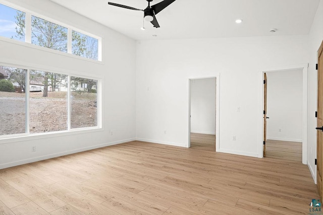 spare room with recessed lighting, ceiling fan, baseboards, and light wood-style floors