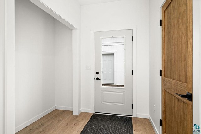 entryway featuring baseboards and light wood-style flooring