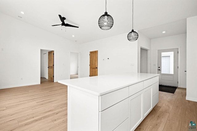 kitchen featuring light wood-style floors, a ceiling fan, white cabinets, and recessed lighting