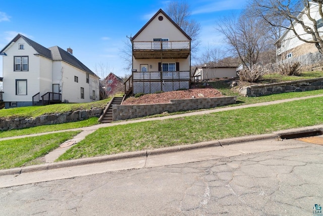 view of front of property with a front lawn and stairway
