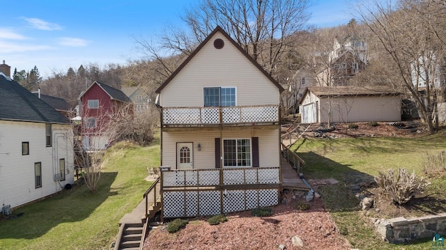 back of property featuring stairway, a yard, and an outdoor structure