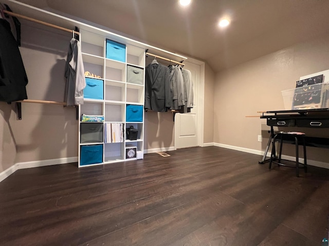walk in closet with wood finished floors