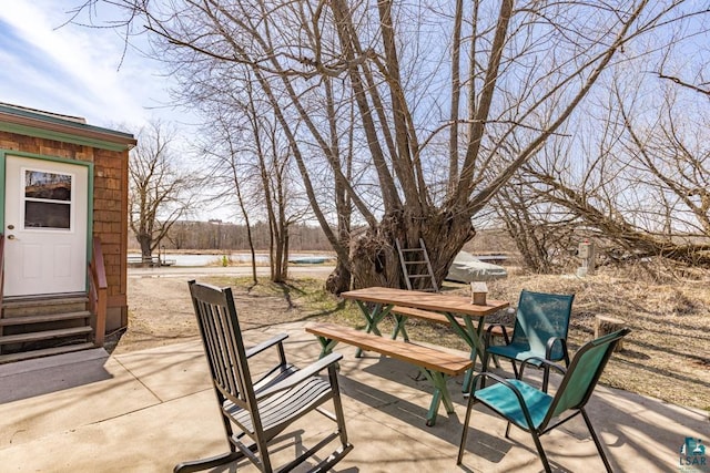 view of patio featuring outdoor dining area and entry steps