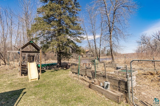 view of yard with a playground and a garden