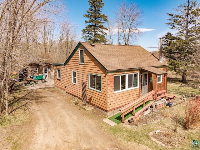 view of home's exterior featuring a shingled roof