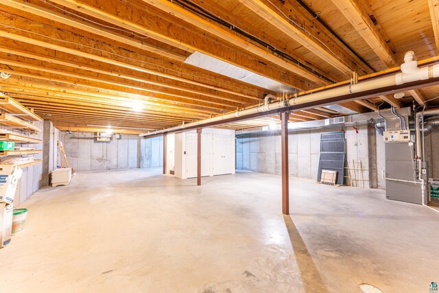 unfinished below grade area with heating unit and visible vents
