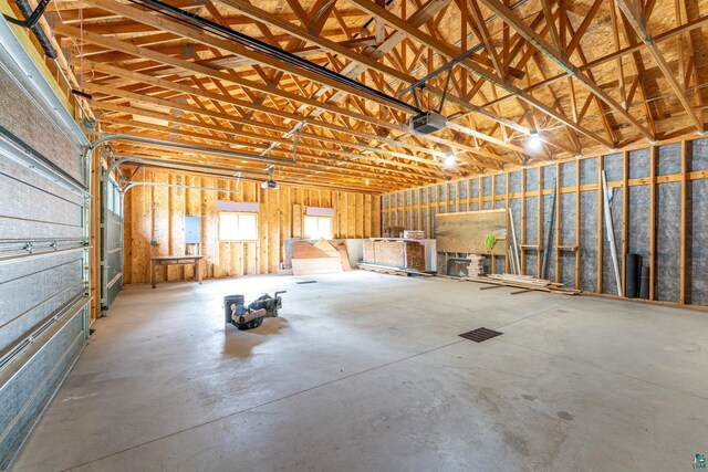 garage with a garage door opener and electric panel