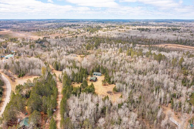 drone / aerial view featuring a wooded view