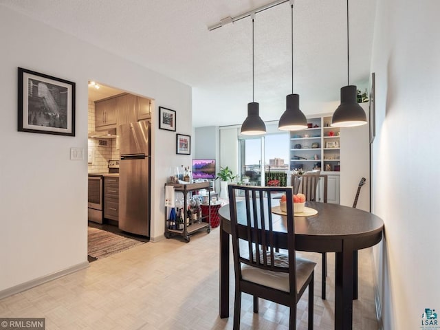 410 Groveland Ave Unit 1203, Minneapolis, MN 55403 - dining room with rail lighting and baseboards