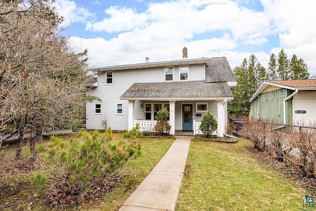 traditional-style home with fence, a shingled roof, a front yard, a chimney, and covered porch