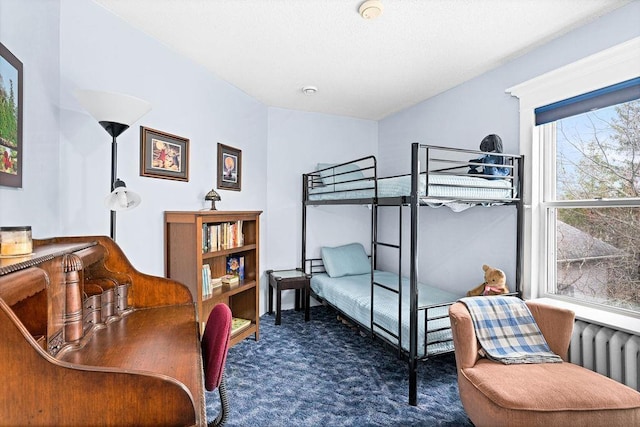 bedroom with carpet floors and radiator