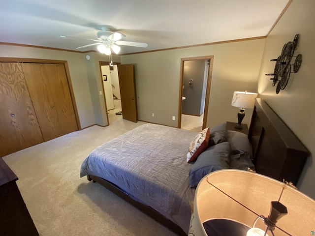 carpeted bedroom featuring crown molding, a ceiling fan, and ensuite bath