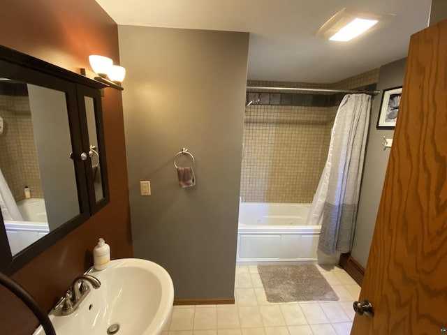 full bathroom featuring tile patterned flooring, a sink, baseboards, and shower / tub combo