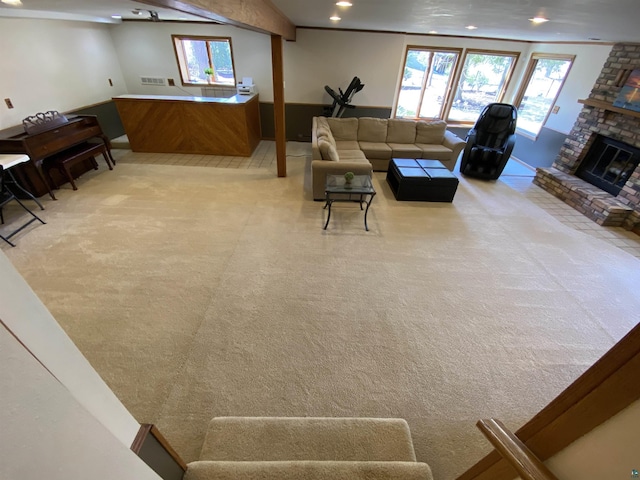 living room featuring carpet flooring, a healthy amount of sunlight, and a fireplace