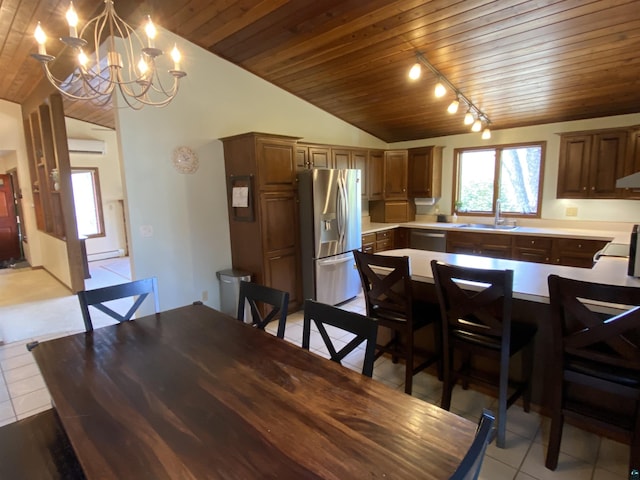 dining space with light tile patterned floors, wood ceiling, and vaulted ceiling