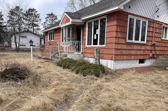 view of home's exterior featuring roof with shingles