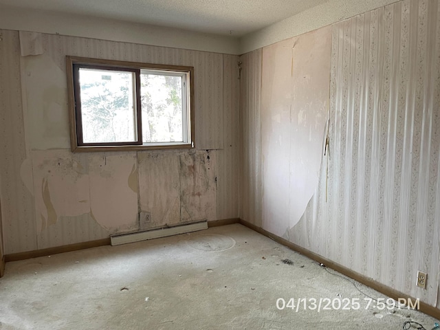 unfurnished room featuring carpet floors, baseboards, wallpapered walls, and a baseboard radiator