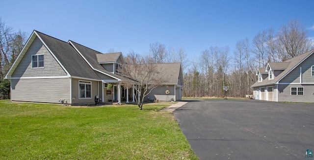 view of property exterior with a garage and a yard