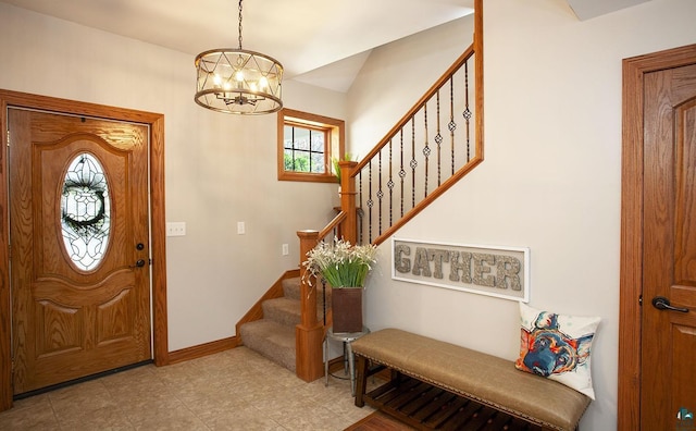 entrance foyer with stairway, baseboards, and a notable chandelier