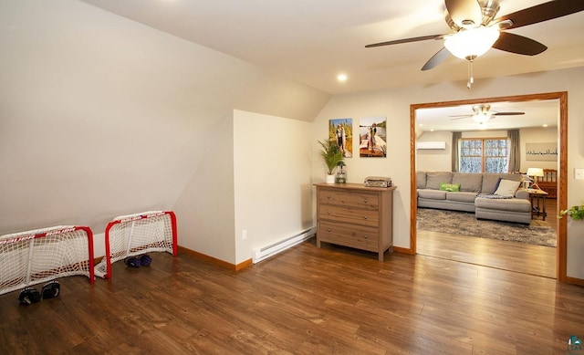 rec room featuring a baseboard radiator, a wall unit AC, ceiling fan, and wood finished floors
