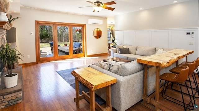 living area featuring a ceiling fan, a wall mounted air conditioner, a wainscoted wall, recessed lighting, and hardwood / wood-style floors