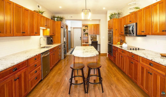 kitchen featuring a sink, tasteful backsplash, stainless steel appliances, and dark wood-style floors