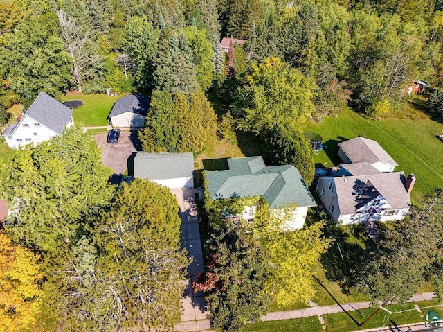 birds eye view of property featuring a view of trees